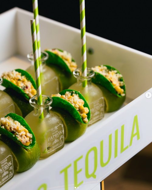 Creative presentation of miniature tacos paired with bottled drinks